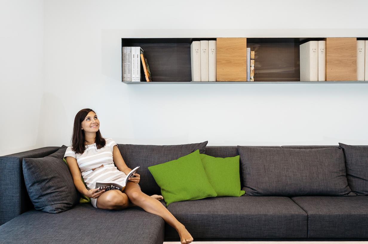 Lady comfortable on sofa in warm living room